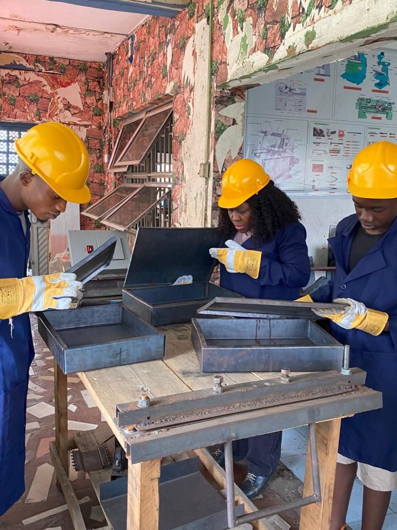 Trainees assembling fabricated metal boxes in the workshop