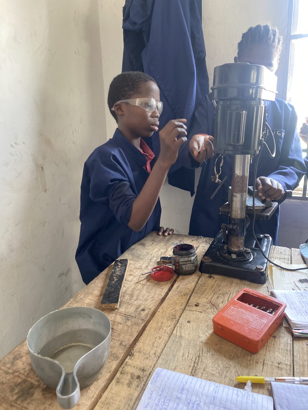 Student using a drilling machine
