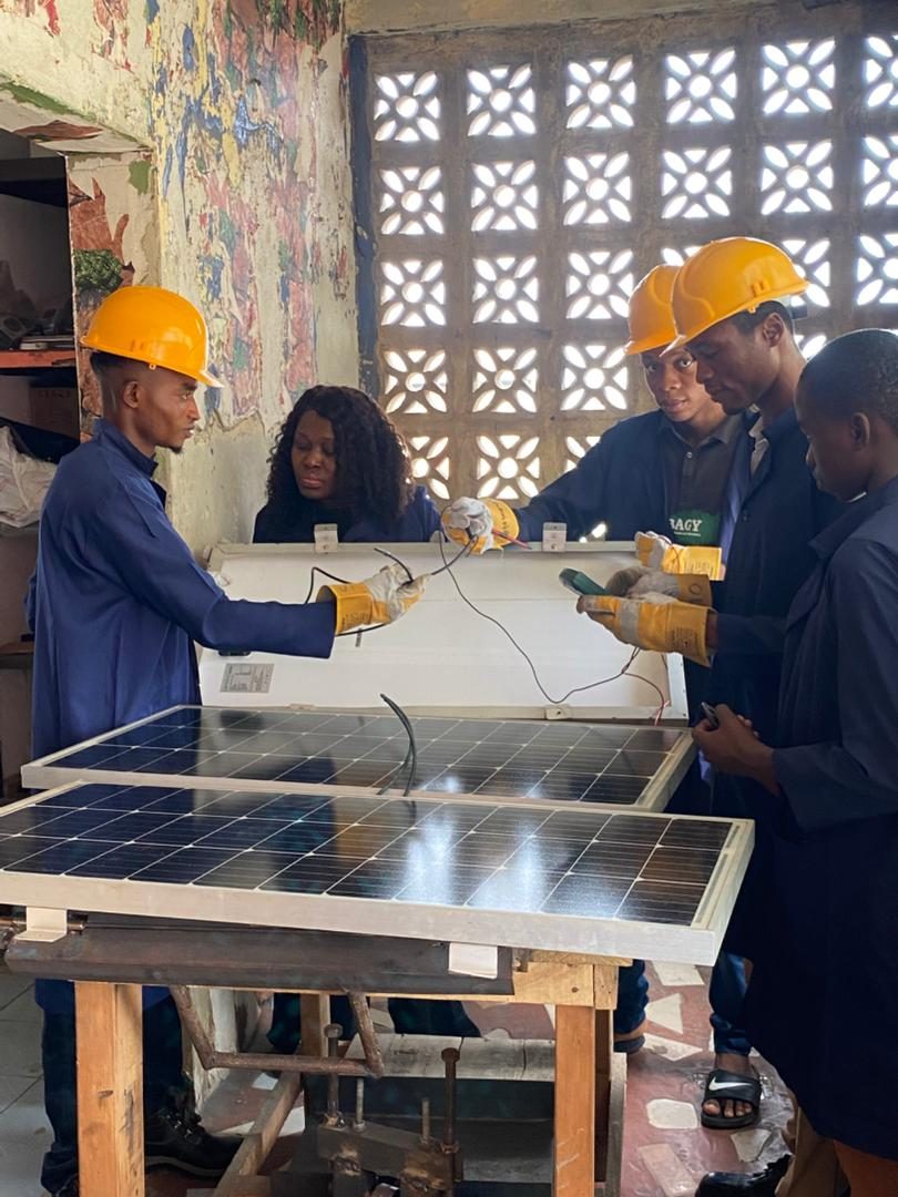Solar PV trainees working with training panels