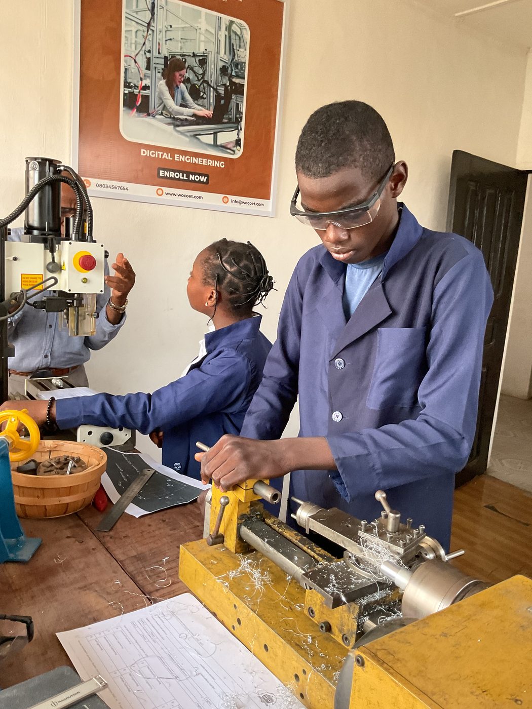Students operating machining equipment
